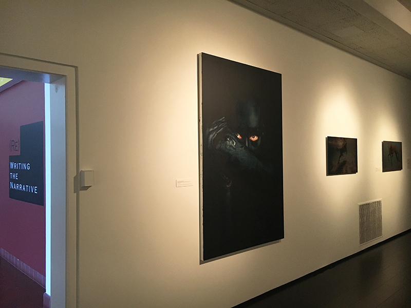 Installation image showing a painting and two photographs on gallery wall.