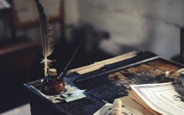old fashioned school desk with inkwell and quill