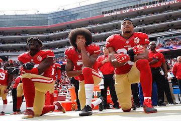 San Francisco 49ers outside linebacker Eli Harold, left, quarterback Colin Kaepernick, center, and safety Eric Reid kneel during the national anthem before the team's NFL football game against the Dallas Cowboys in Santa Clara, Calif. Kaepernick accepted Sports Illustrated's Muhammad Ali Legacy Award from Beyonce on Tuesday night, Dec. 5, 2017, and promised that 