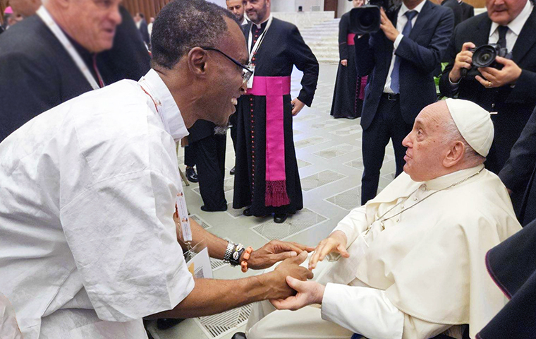 JST Dean Orobator greeting Pope Francis who is seated in a wheelchair, during the Synod on Synodality
