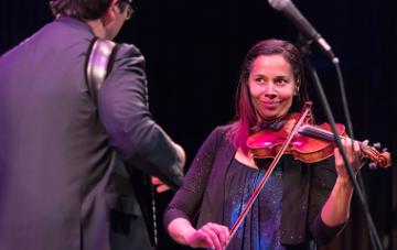Rhiannon Giddens plays fiddle next to accordion player and musical partner Francesco Turrisi. 