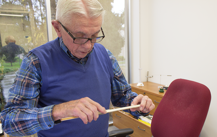 Engineering Professor Tim Healy demonstrates how to use his old slide rule, which were replaced with calculators after he arrived at Santa Clara.
