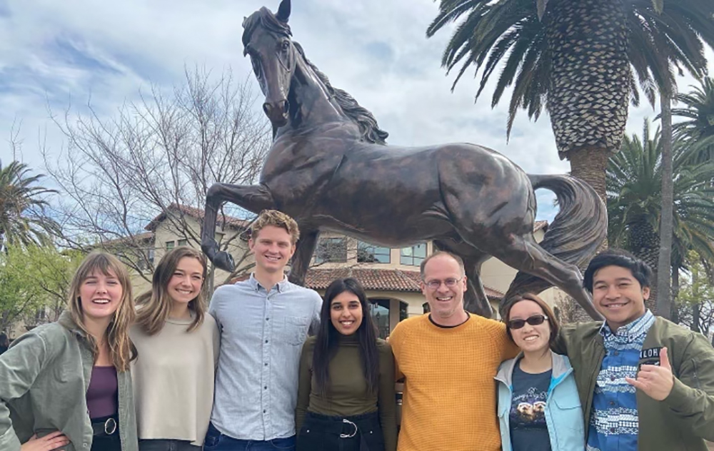 Isha Vial and her labmates in front of the Bronco statue.