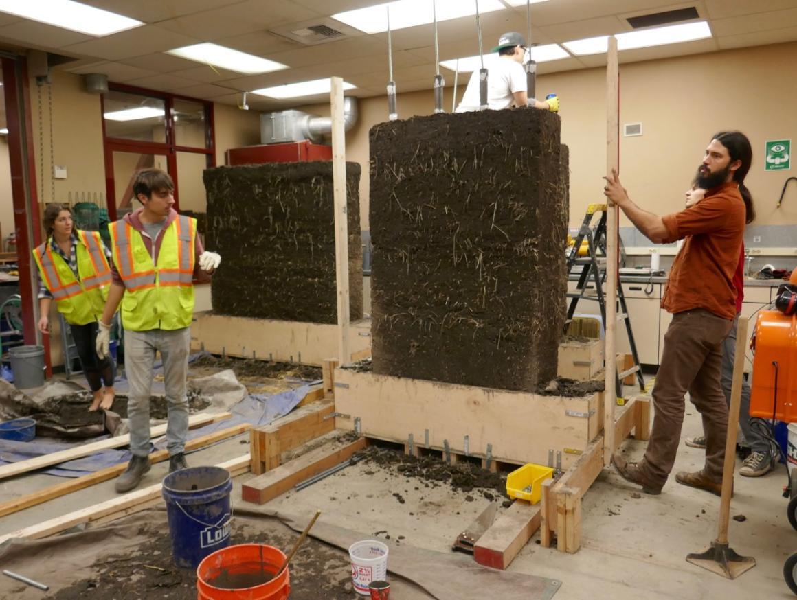 Mark Aschheim's students building cob test walls in a SCU civil engineering lab; CRI board member Anthony Dente is at far right.