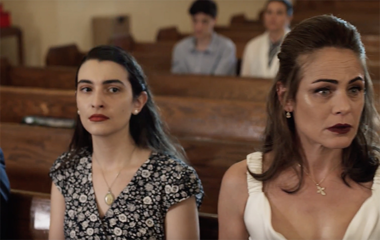 Marialisa Caruso sits in a church pew in the film Emerald Run