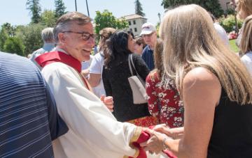 President Kevin O'Brien shaking the hand of a staff member after the Feast of St. Ignatius