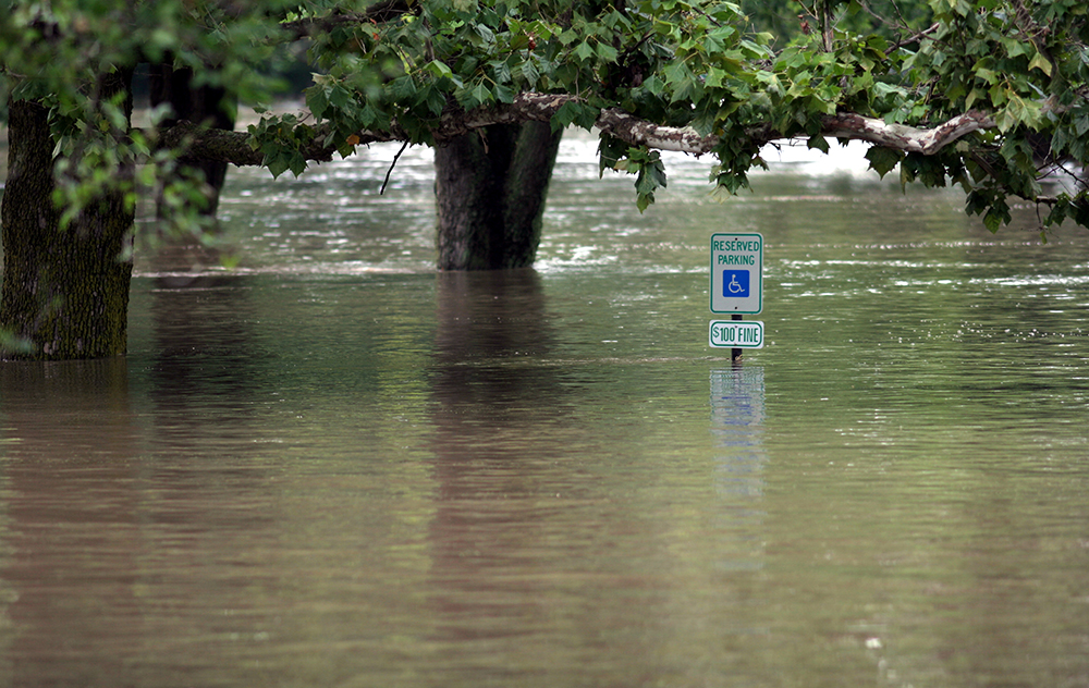 A handicapped parking sign in flood