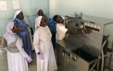 Sisters in East Africa around a machine