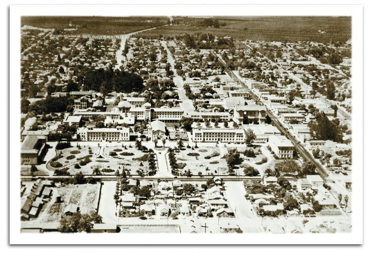 An aerial view of Santa Clara University campus circa 1940, with orchards still in close proximity to academic facilities.