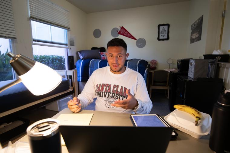 SCU student working at his desk