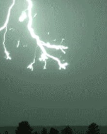 Bright lightening coming down from the top left frame of the picture, extending half way to the ground