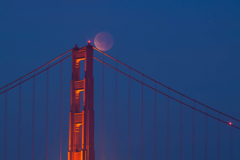 A total lunar eclipse seen over the Golden Gate Bridge is a striking image!