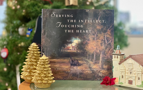 A book sitting in front of a Christmas tree.