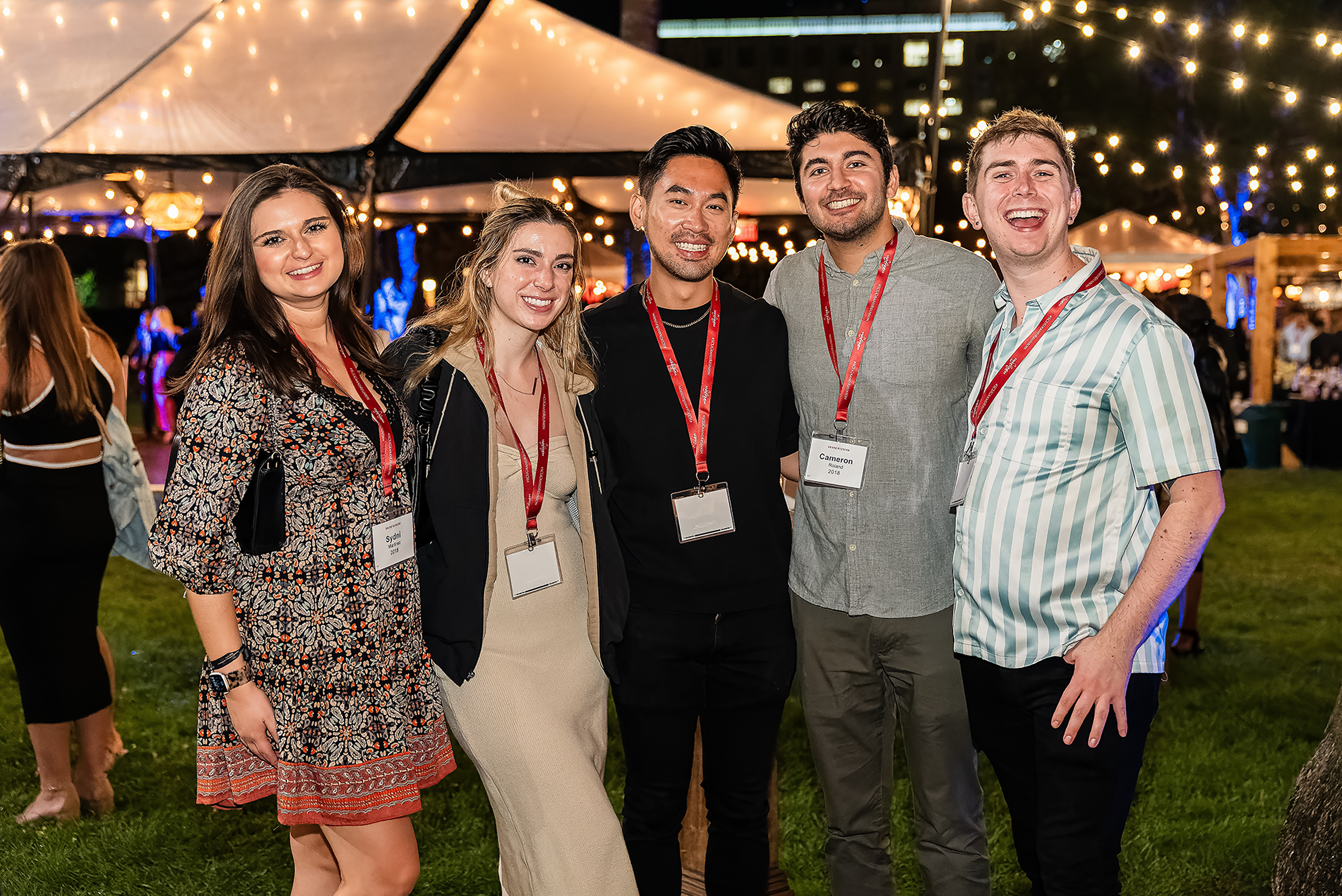 Group of young alumni arm in arm at Grand Reunion