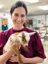 Kathleen Chopra-McGowan holding a kid goat