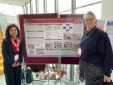 Jesica S. Fernandez with Professor/Dr. Cath Larkins (University of Lancashire, UK) standing next to a conference poster
