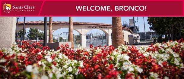 A picture of the white and red flowers outside of Stevens Stadium with a banner across the top that reads,Welcome, Bronco