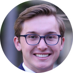 A person wearing glasses smiling in a circular-framed headshot.