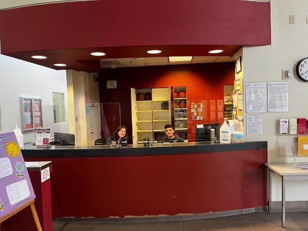 Two employees workingat malley center front desk