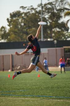 A member of womens ultimate catching a frisbee
