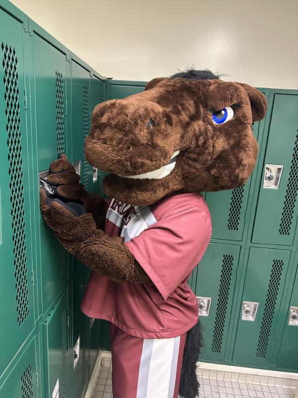In this picture, the school mascot, the horse bucky, opens a locker.