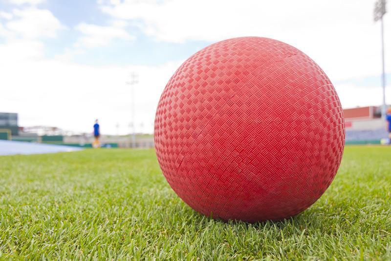 Red Kickball sitting on grass