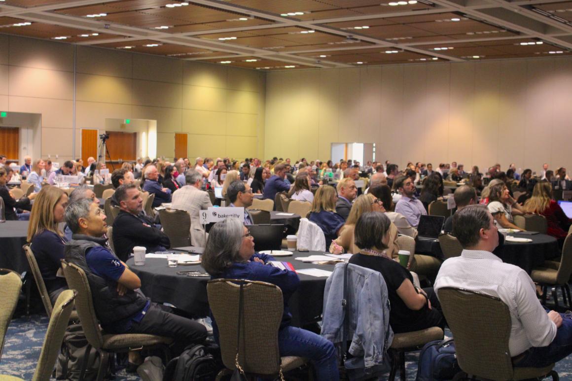 Conference room of people seated at table