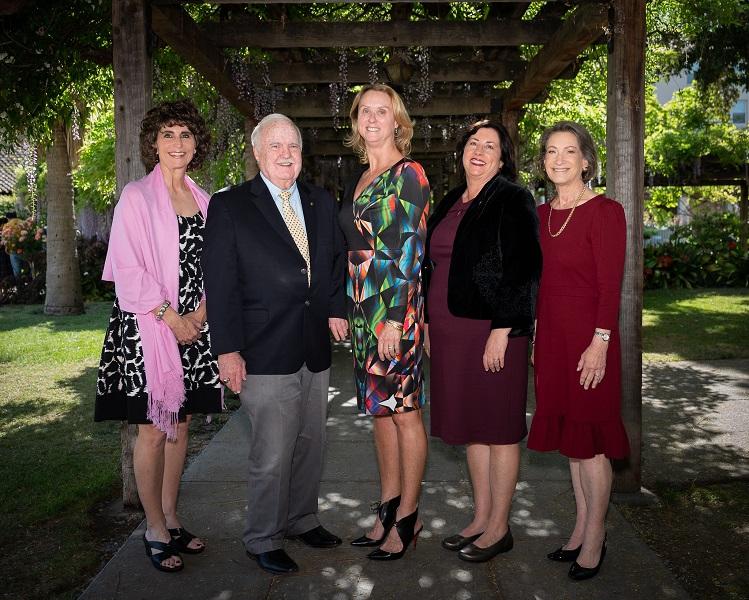 A group of Santa Clara Alumni pose for a picture with the university Provost 