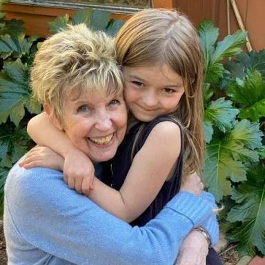 Jo Burr Margadant hugging granddaughter image link to story