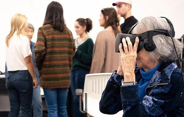 Woman sits in Imaginarium wearing virtual reality display