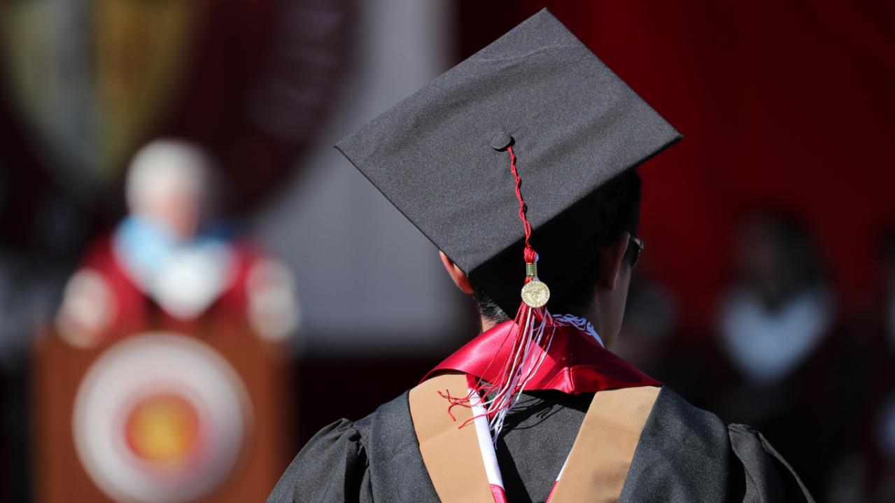 An SCU graduate looking at the commencement stage 