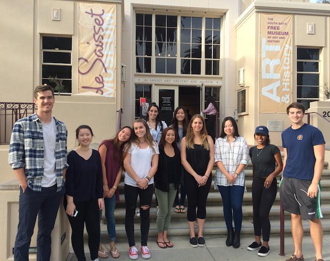A group of students stands in front of a building. image link to story