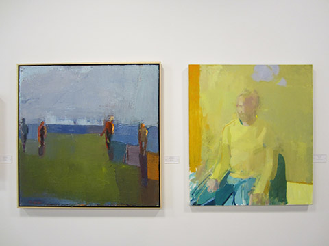 Two abstract paintings on display at an exhibition.