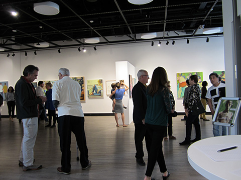 People viewing artwork in a gallery setting.