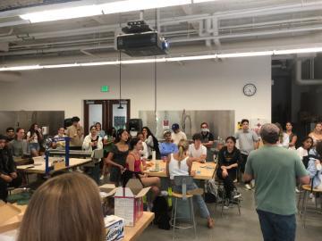A group of people seated in a large room for an event.