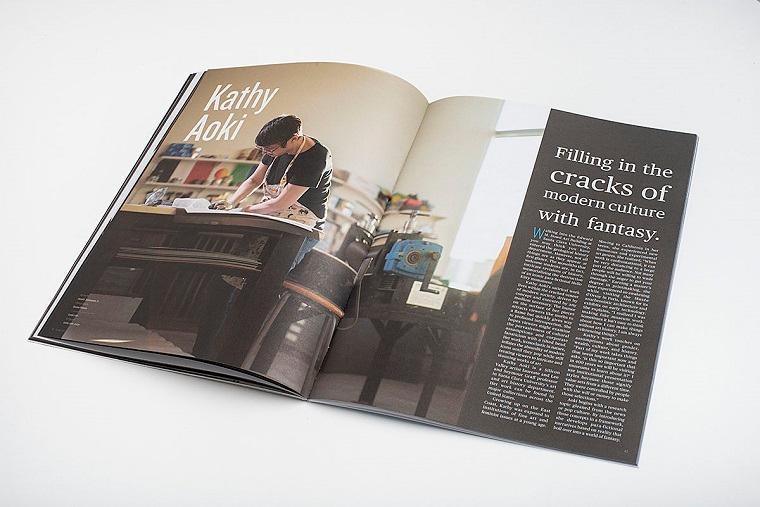 Open book showing pages with art and text, titled 