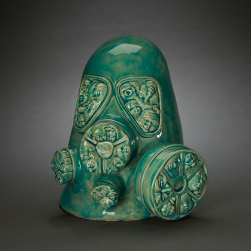 Green gas mask with round filters against a dark background. image link to story