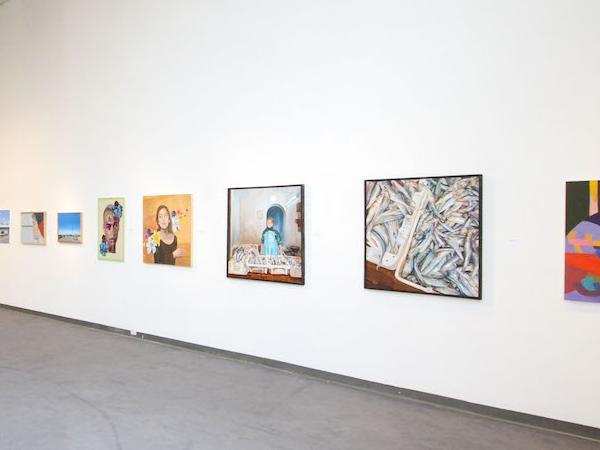 A gallery wall displaying various framed artworks. image link to story