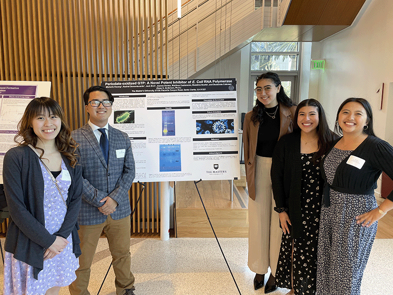 Five students stand next to their poster