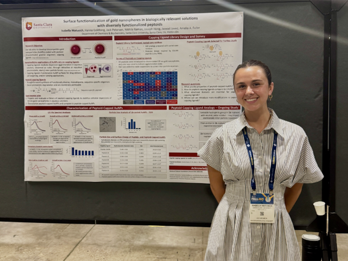 Bella Matusich standing by her research poster