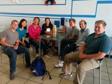 A group of people sitting in a lab with drinks. image link to story