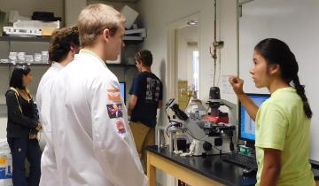 Students in a lab during an open house event. image link to story