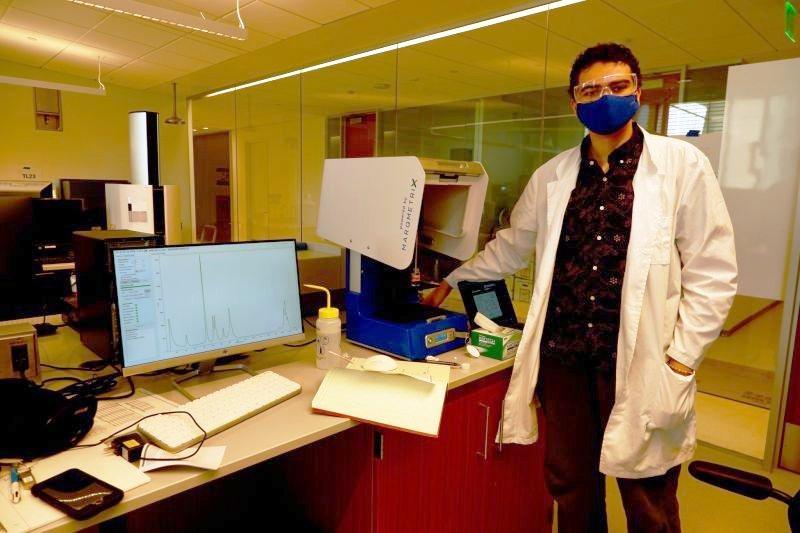 Elliott Anderson in lab wearing lab coat