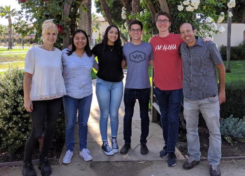 Paul Abbyad and five students that work in his lab standing in front of a rose arch image link to story