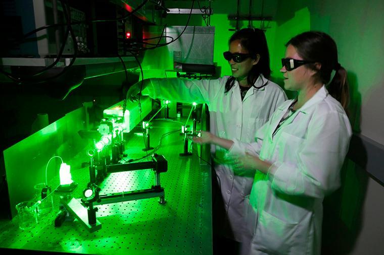 Grace Stokes and Jacenda Rangel '18 (Biochemistry) working in the laser lab.