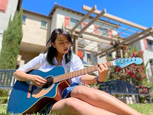 Primrose Waranimman playing a guitar image link to story