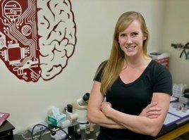 Lindsay Halladay standing in front of brain decoration