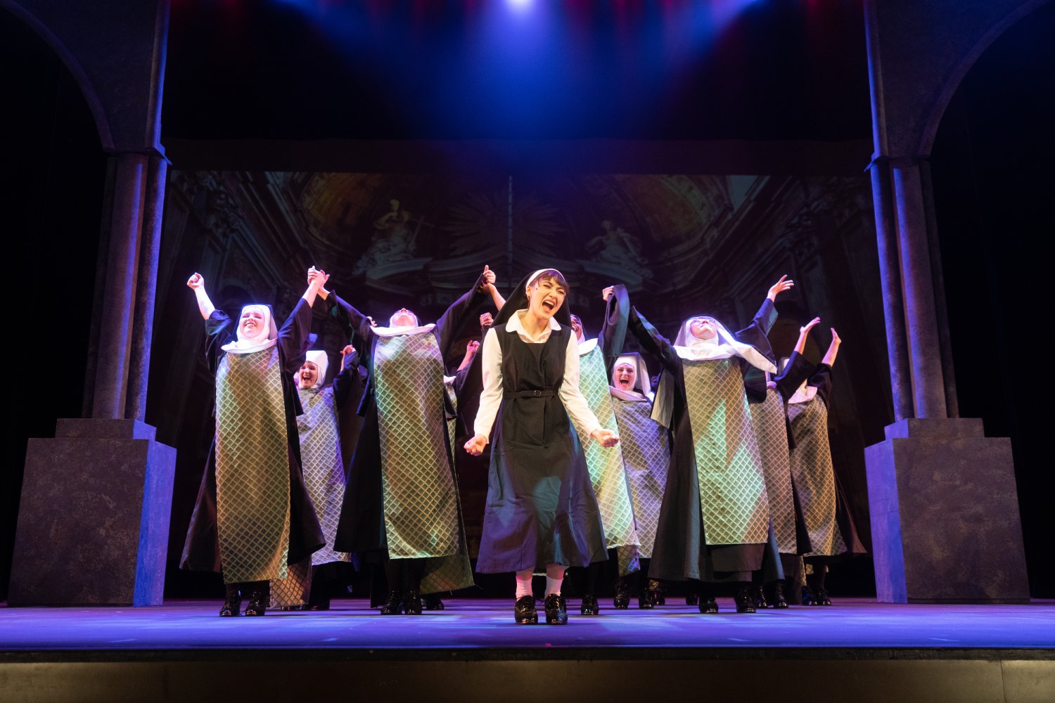 Ensemble shot of nuns singing in Sister Act