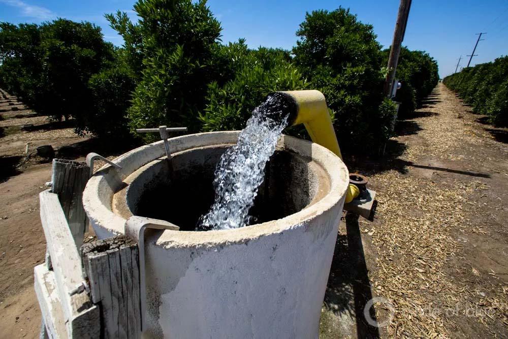 A well being filled with water in the central valley