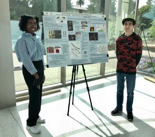 Aleimah Andrew and Sean Duffy in front of their scientific poster